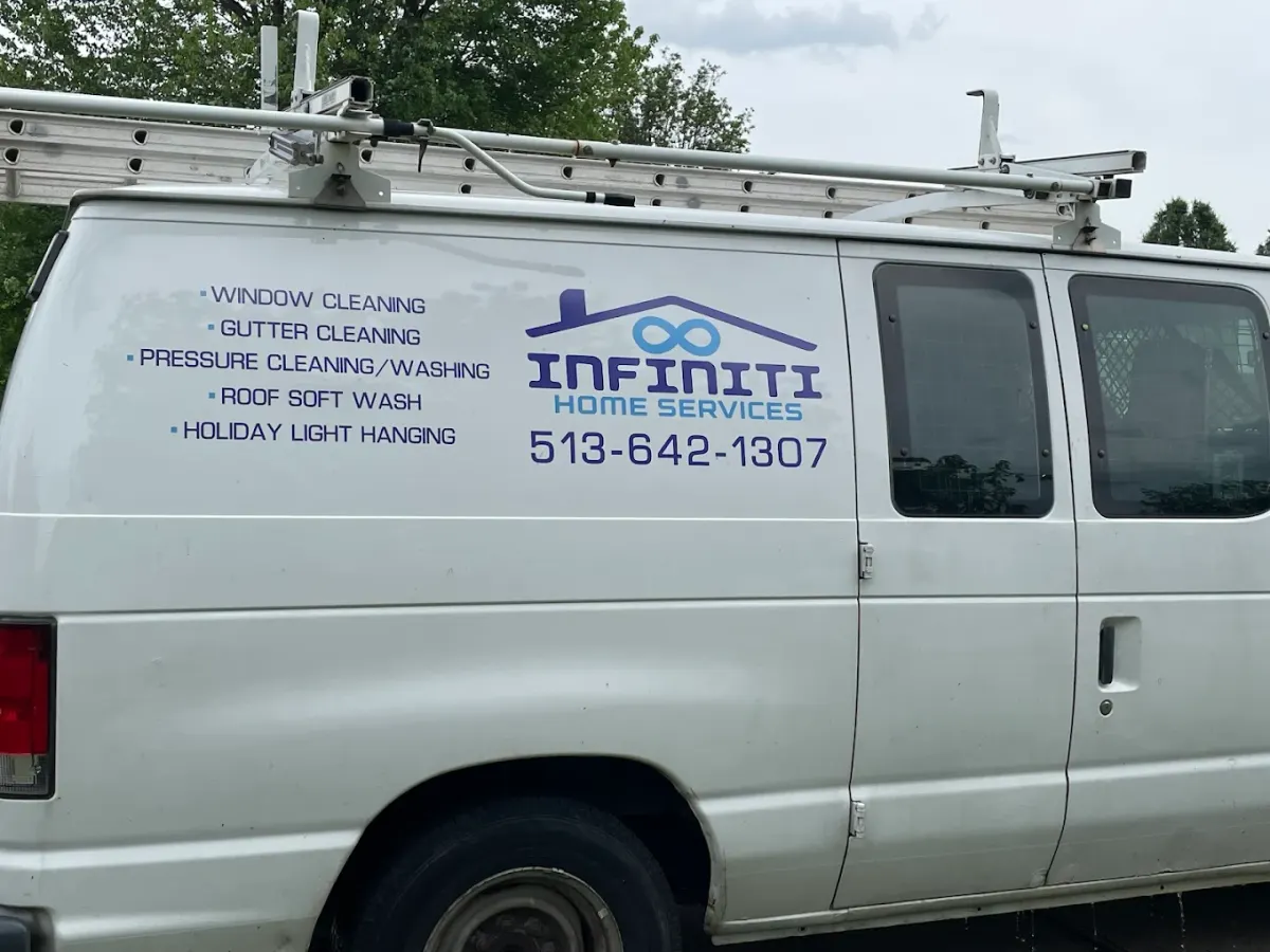 White Infiniti Home Services van with ladder rack and the phone number on the side