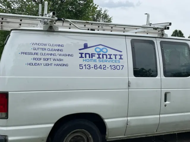 White Infiniti Home Services van with ladder rack and phone number